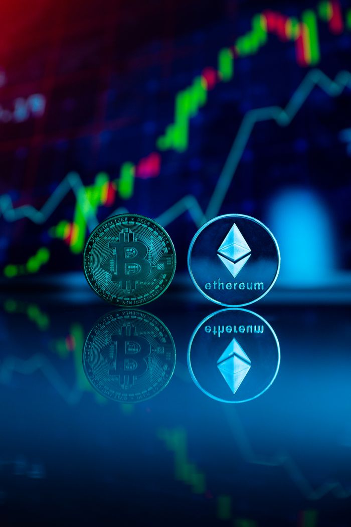 why-choose-us Conceptual image of Bitcoin and Ethereum coins reflecting stock market graph for cryptocurrency trading.