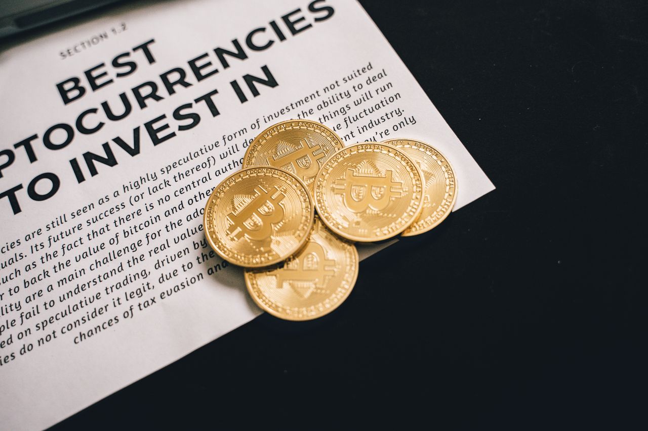 Services-01 Close-up of Bitcoin coins on investment document promoting cryptocurrencies.